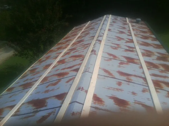 Rusted metal roof panels with new wood purlins before replacement — Storm Damage Roof Repair in Keymar by Roofing Brothers