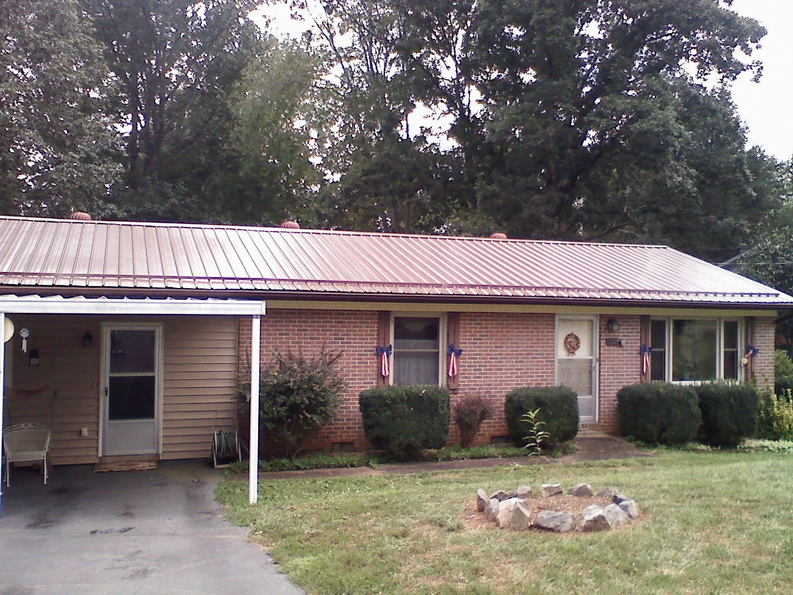 Bronze metal roof and carport on a brick ranch home — Roof Repair work by our crew in Keymar